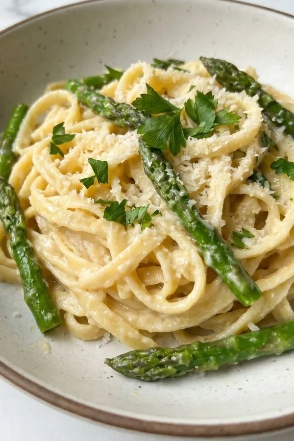 Lemon garlic asparagus pasta in a creamy sauce served in a bowl
