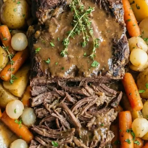 Instant Pot pot roast with tender chuck roast, carrots, and potatoes in a rich savory gravy, easy comfort food dinner.