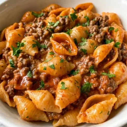 Ground beef and completely smooth tomato broth simmering fiercely in a heavy skillet before adding thick cream and dry pasta shells.