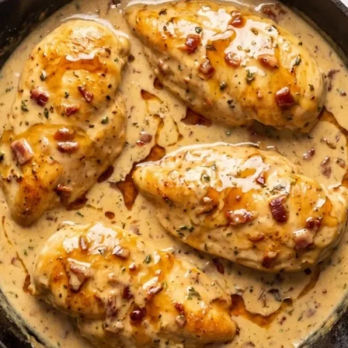 Golden brown pan-fried chicken cutlets simmering fiercely in a thick, rich creamy maple and Dijon mustard sauce.