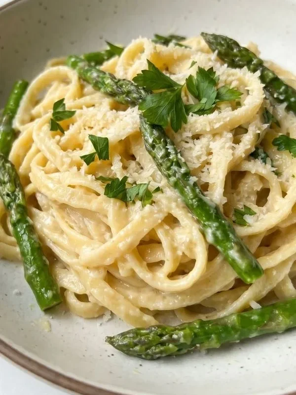 Lemon garlic asparagus pasta in a creamy sauce served in a bowl
